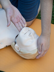 First aid training - mastering CPR techniques on a dummy