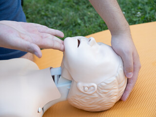 First aid training - mastering CPR techniques on a dummy