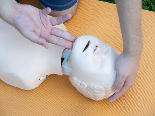 First aid training - mastering CPR techniques on a dummy