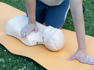 First aid training - mastering CPR techniques on a dummy