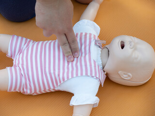 First aid training - mastering CPR techniques on a dummy