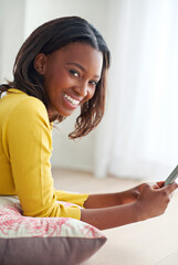 Phone, smile and portrait of black woman relaxing in home with good news email for mortgage approval. Happy, cellphone and African female person online for credit application in living room at house.