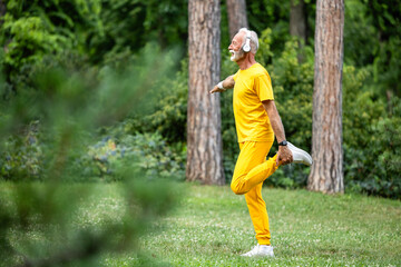 Fit senior man exercising in nature enjoying healthy lifestyle.