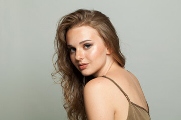 Naklejka premium Perfect smiling young adult woman studio photo