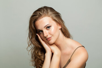 Naklejka premium Nice young lady with makeup and long wavy hair, closeup portrait. Beautiful woman