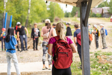 Group of friends trekking with backpacks walking in the forest.