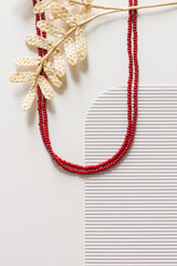 A necklace of red bead on a white background