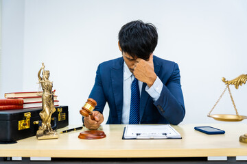 A male Asian lawyer in a formal suit navigates contracts, agreements, and legal obligations amidst...