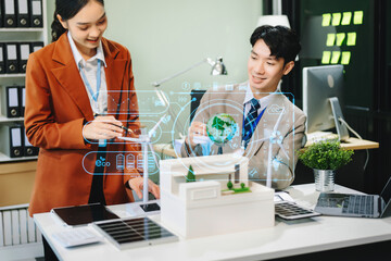 businesspeople standing neare table looking at model of building from residential project. Green business company and Solar Energy