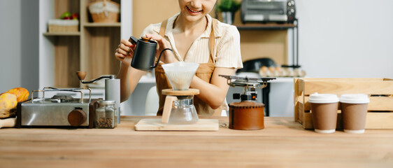Asian barista brewing fresh espresso. Enjoy a cozy, trendy cafe experience with high quality beans in home or cafe