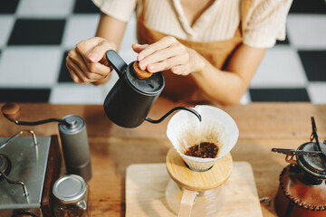 Asian barista brewing fresh espresso. Enjoy a cozy, trendy cafe experience with high quality beans in home or cafe