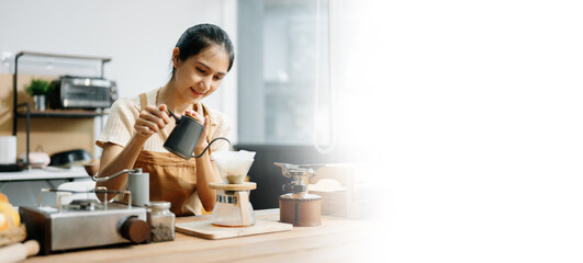 Asian barista brewing fresh espresso. Enjoy a cozy, trendy cafe experience with high quality beans in home or cafe