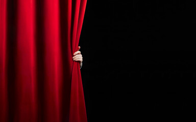 hand open red stage curtain on black background