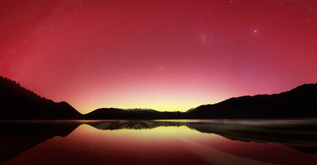 The Aurora Australis lights up the night sky above a lake near Rotorua, New Zealand