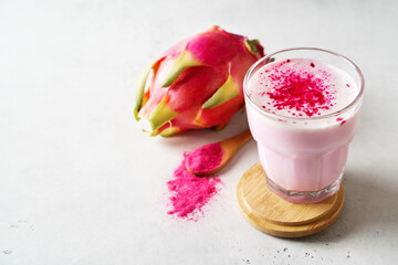 Pink matcha latte with powder on white background