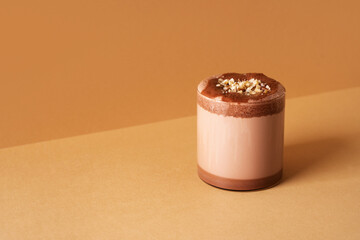Protein chocolate cocktail drink in glass on brown background
