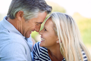Mature, couple and happy outside with affection, nature and weekend break in summer with love. Romance, trust and support for bonding together in outdoor park, smile and man or woman for relationship