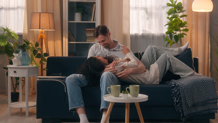 Happy family couple at home Caucasian man guy male working laptop distant freelancer Hispanic...