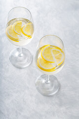 Hugo Spritz Cocktail in Glass with Lemon on Gray Background, Summer Alcoholic Drink