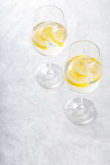 Hugo Spritz Cocktail in Glass with Lemon on Gray Background, Summer Alcoholic Drink