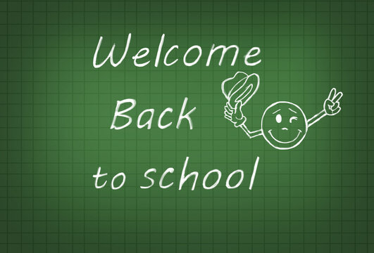 'Welcome back to school 'invitation message with funny emoji chalk drawing on teal green math cutting line schoolboard. Positive back to school education concept. Flat lay, free copy space.