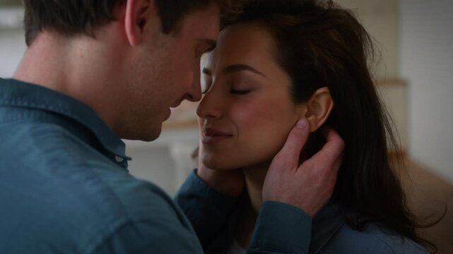 Home happy couple love married lovely smiling talking people forehead touch bonding together man Caucasian guy boyfriend male husband cuddling woman female girl wife girlfriend anniversary romantic