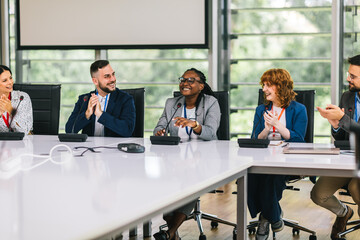 African American woman CEO talking on the microphone on meeting with her colleagues about business plan, future collaboration.