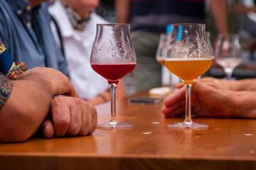 People cheer the party with craft beer in a sommelier glass with bokeh background