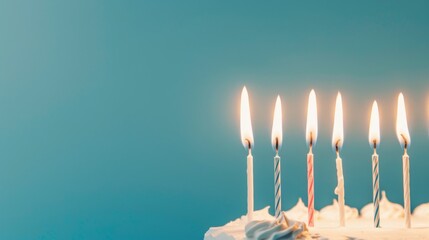 a cake topped with a row of brightly lit birthday candles. Birthday Traditions Built Around the Cake