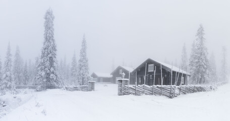 Cabin in mist in snowy view , in norway