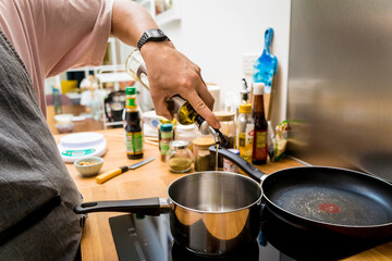 Chef at the kitchen preparing pumpkin porridge with tofu and vegetables