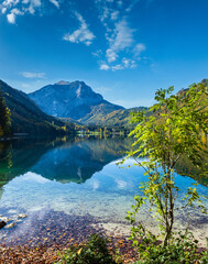 Peaceful autumn Alps mountain lake with clear transparent water and reflections. Langbathseen lake, Upper Austria.