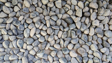 Closeup of smooth round pebbles on the ground