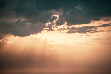 rays of beautiful sun through the clouds and thick fog on the eve of a thunderstorm front and lightning on the horizon