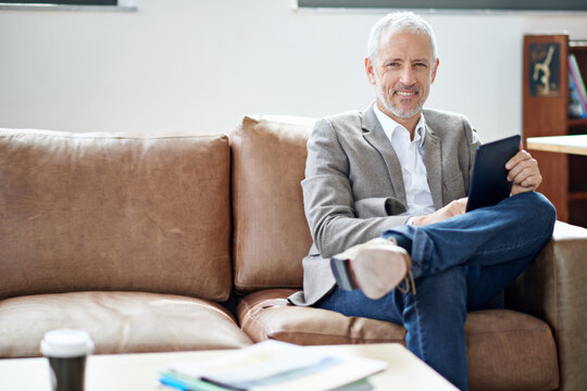 Sofa, portrait and mature man with tablet for reading news, information and topic of interest in home. Couch, male reader and relax with online article, current events and digital story for knowledge