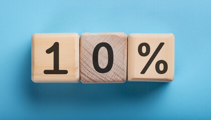 Wooden cubes with text 10% on isolated blue backdrop. Wood blocks, ten percent. Close-up. Flat lay