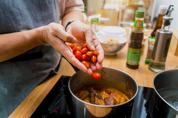 Chef at the kitchen preparing massaman curry with sweet potato and many spices