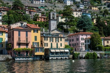 Scenic view of colorful buildings and a clock tower by the lake Como, Italy