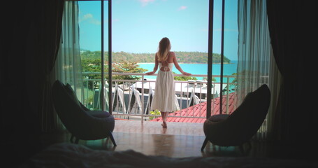Beautiful caucasian woman on balcony, enjoy ocean view from hotel room apartment, sunny day....