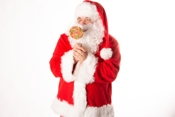 Bad Santa Claus undresses. A man posing in the studio.