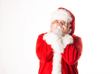A man dressed as Santa Claus poses in the studio.