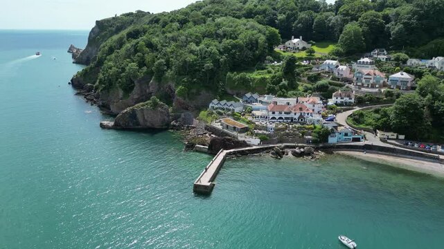 Babbacombe, South Devon, England: DRONE VIEWS: The drone circles Babbacombe beach and harbour wall as a tourist boat sails the coastline. Babbacombe is a popular UK holiday destination (Clip 15).