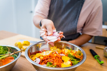 Chef at the kitchen preparing spicy glass noodle salad