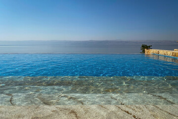 Scenic view at Dead Sea looking form Jordan towards Israel with a swimming pool in the foreground