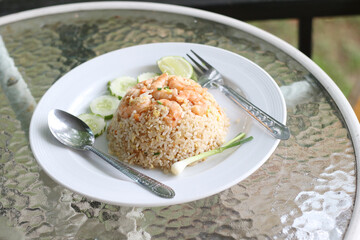 Shrimp fried rice in a plate with fork and spoon