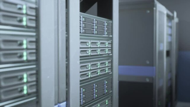 Multiple servers arranged neatly in rows inside a server room, with blinking lights indicating data processing and storage.