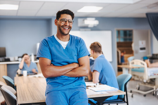 Happy young man undergoing nursing training in a hospital