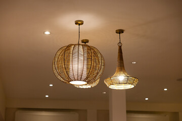 Three light fixtures hanging from the ceiling, one of which is a large