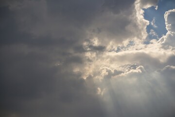 The sky is cloudy and the sun is shining through the clouds