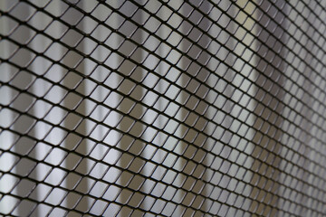 A close up of a metal mesh with a lot of small squares